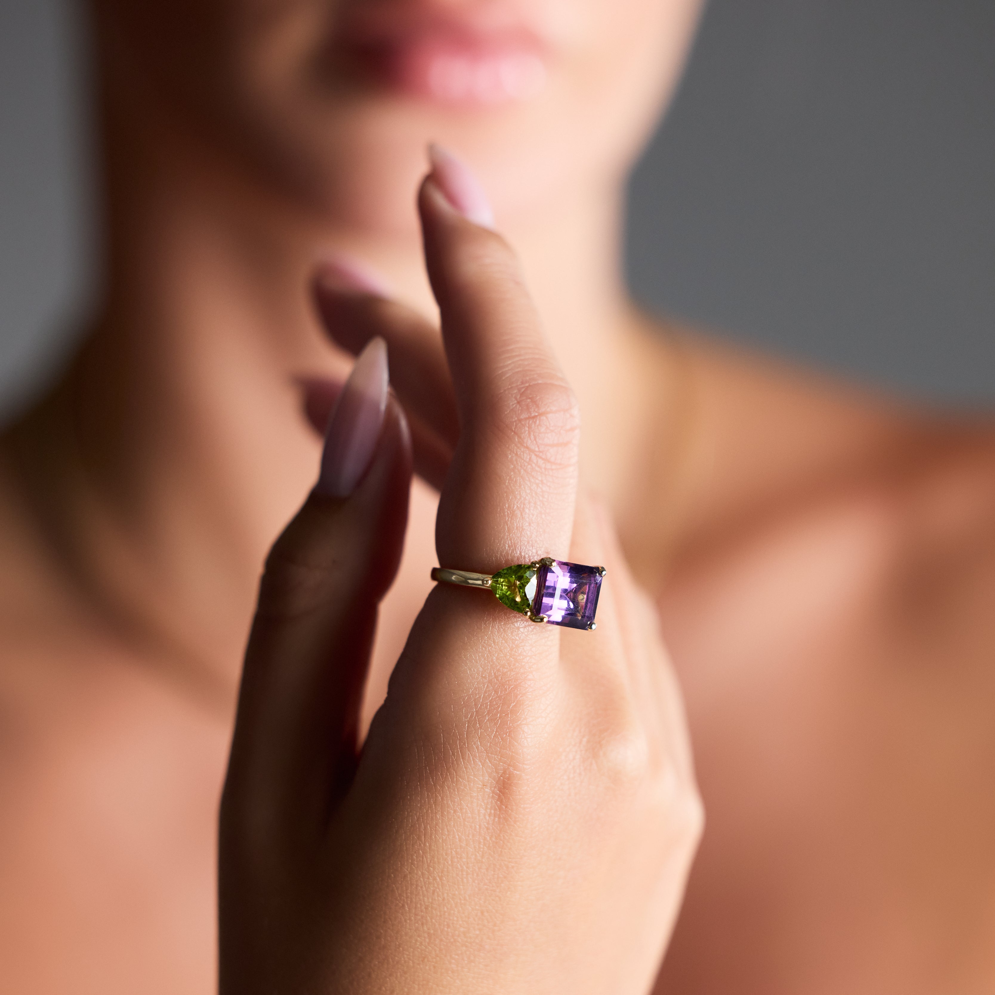 Emerald-cut amethyst ring with pear peridots in gold