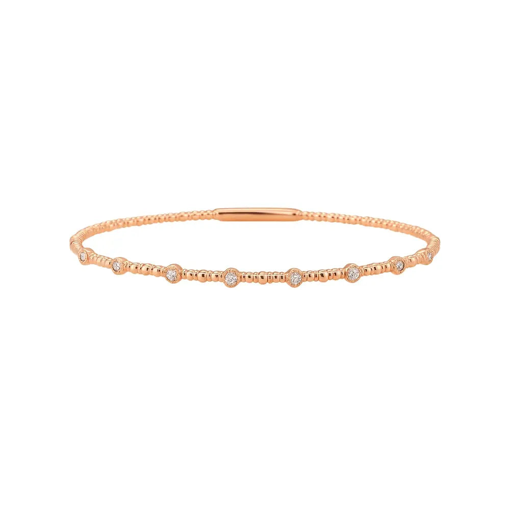 Flexible 18K gold bangle with bezel-set diamonds everyday jewelry