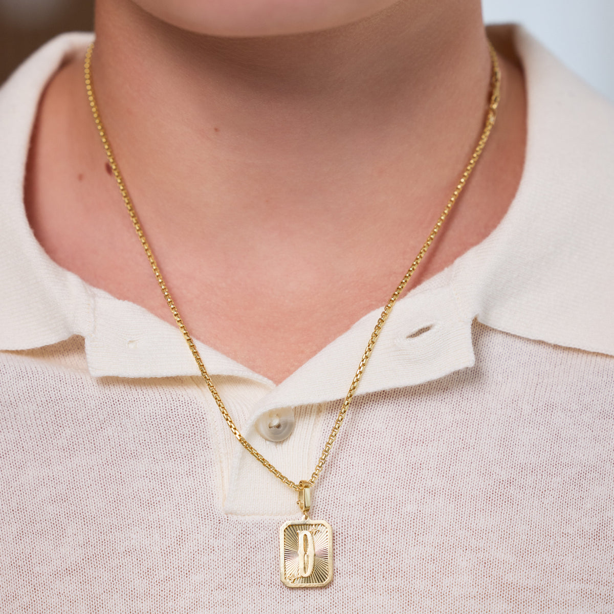 Small Initial Medal Pendant in 18K Yellow Gold, letter J, worn on a gold chain | JJ Jewelry Miami