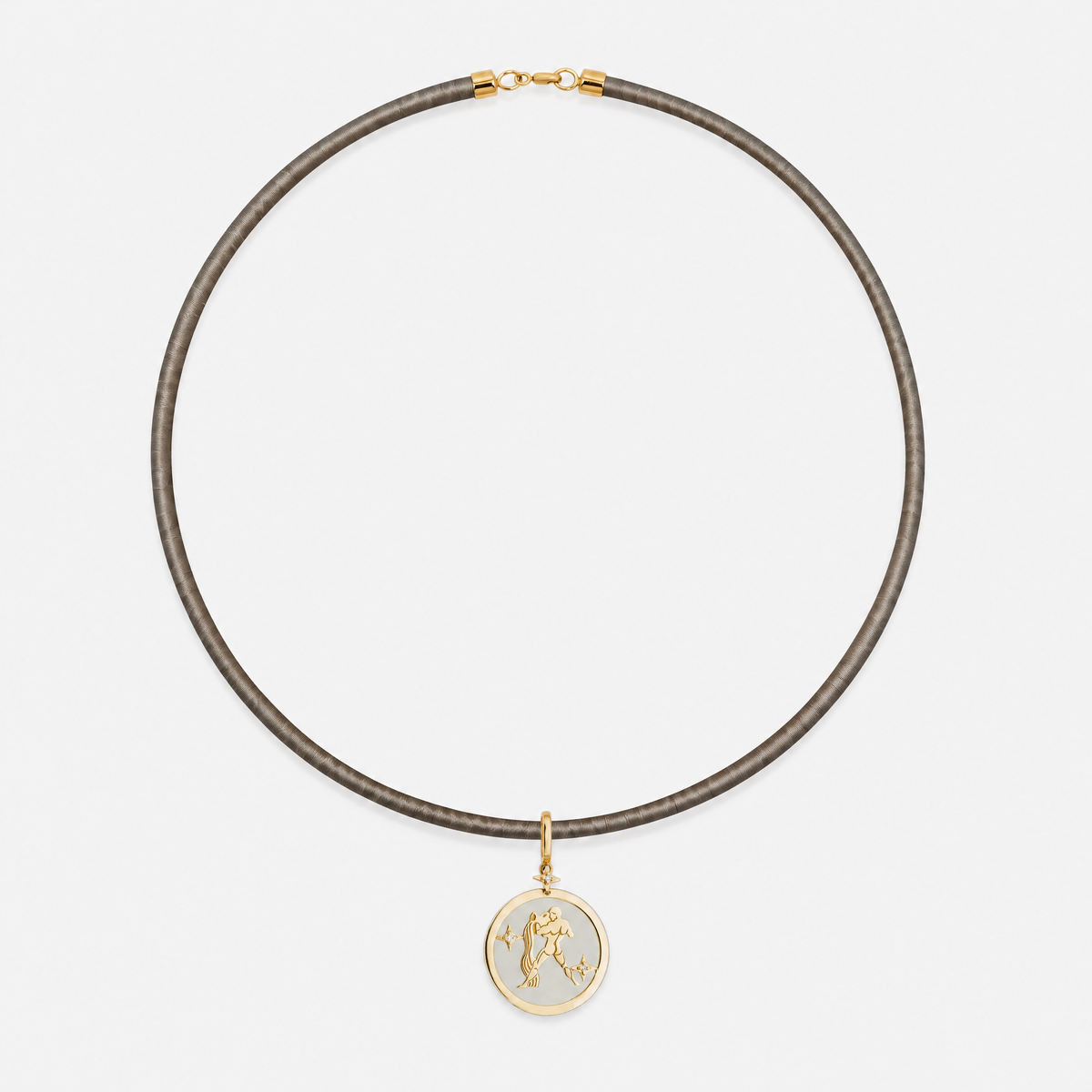 Aquarius Zodiac Pendant in 18K Yellow Gold with White Quartz & Diamonds, styled on a taupe cord choker | JJ Jewelry Miami