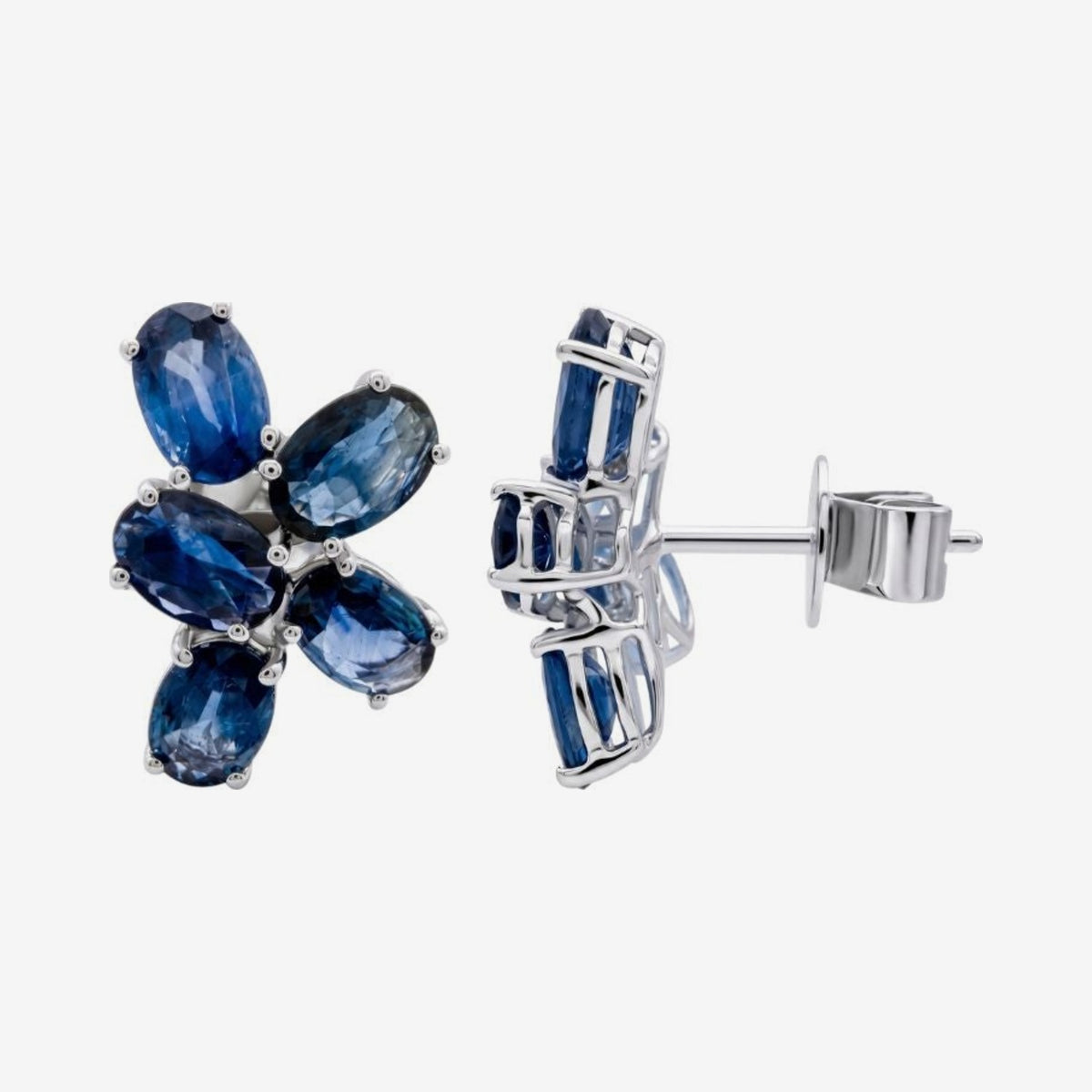 Blue Sapphire Flower Cluster Earrings in 18K White Gold, gray background | JJ Jewelry Miami