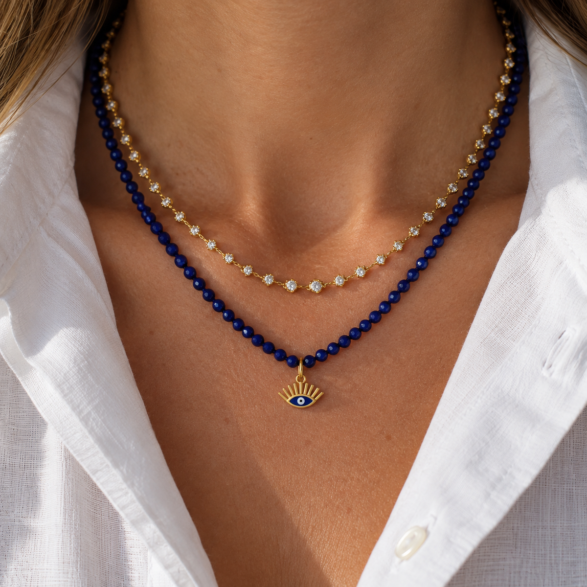 Enamel Evil Eye Pendant in 14K Yellow Gold, layered with a lapis bead necklace | JJ Jewelry Miami