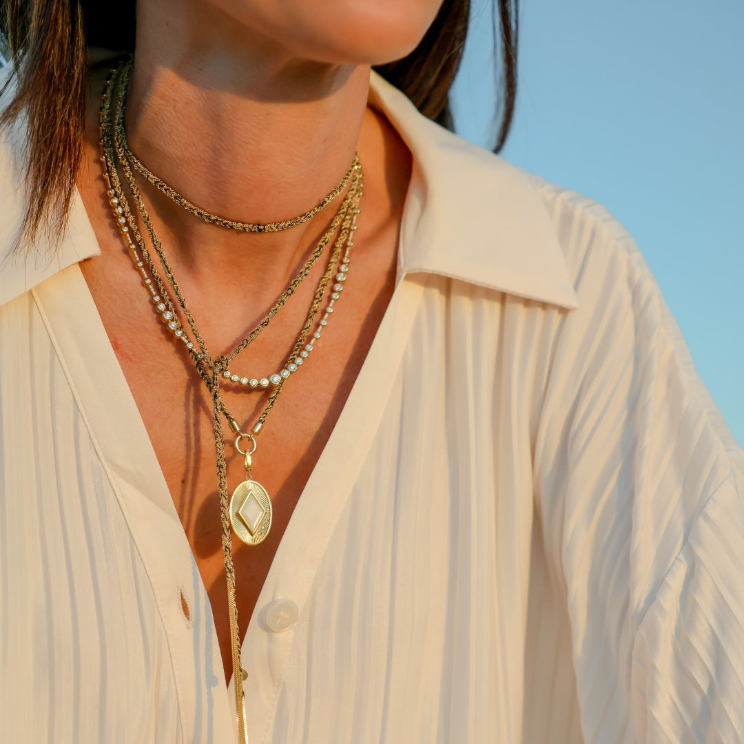 Fluted Oval Gemstone Pendant in 18K Yellow Gold, Mother of Pearl, layered with gold chains | JJ Jewelry Miami