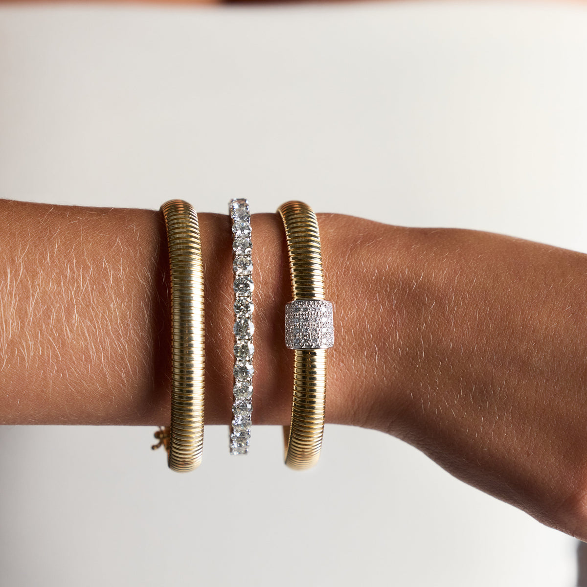 Italian Snake Flexible Bracelet with Pavé Diamond Barrel in Yellow Gold, lifestyle view 1 | JJ Jewelry