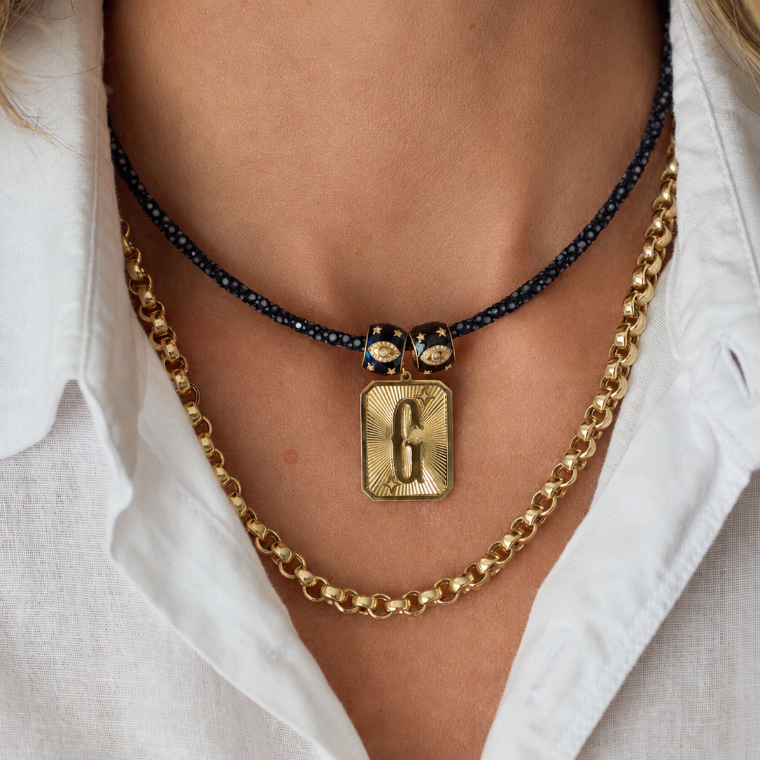 Large Initial Medal Pendant in 18K Yellow Gold, letter G, on a navy choker layered with a gold chain | JJ Jewelry Miami