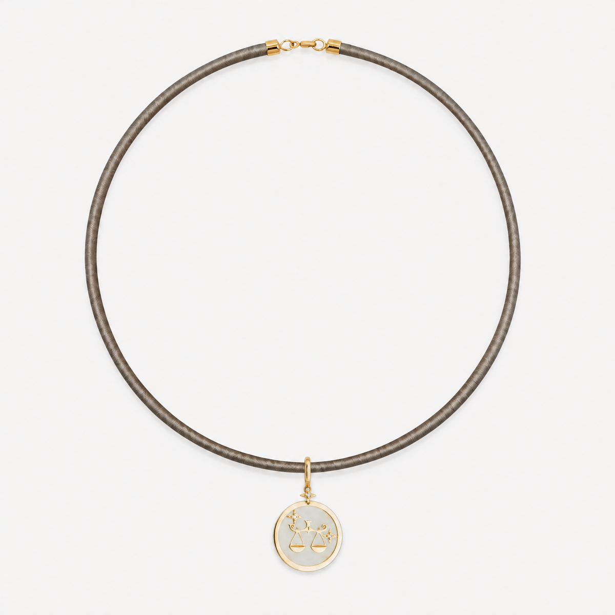 Libra Zodiac Pendant in 18K Yellow Gold with White Quartz & Diamonds, styled on a taupe cord choker | JJ Jewelry Miami