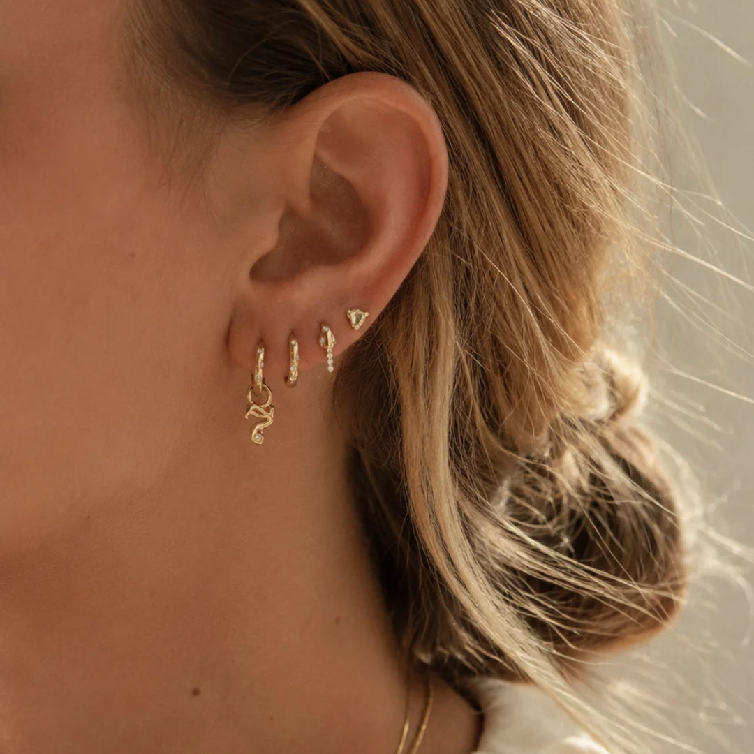 Mini Diamond Number Charm in 18K Yellow Gold by Alessa Rocks, worn on a huggie in an ear stack | JJ Jewelry Miami