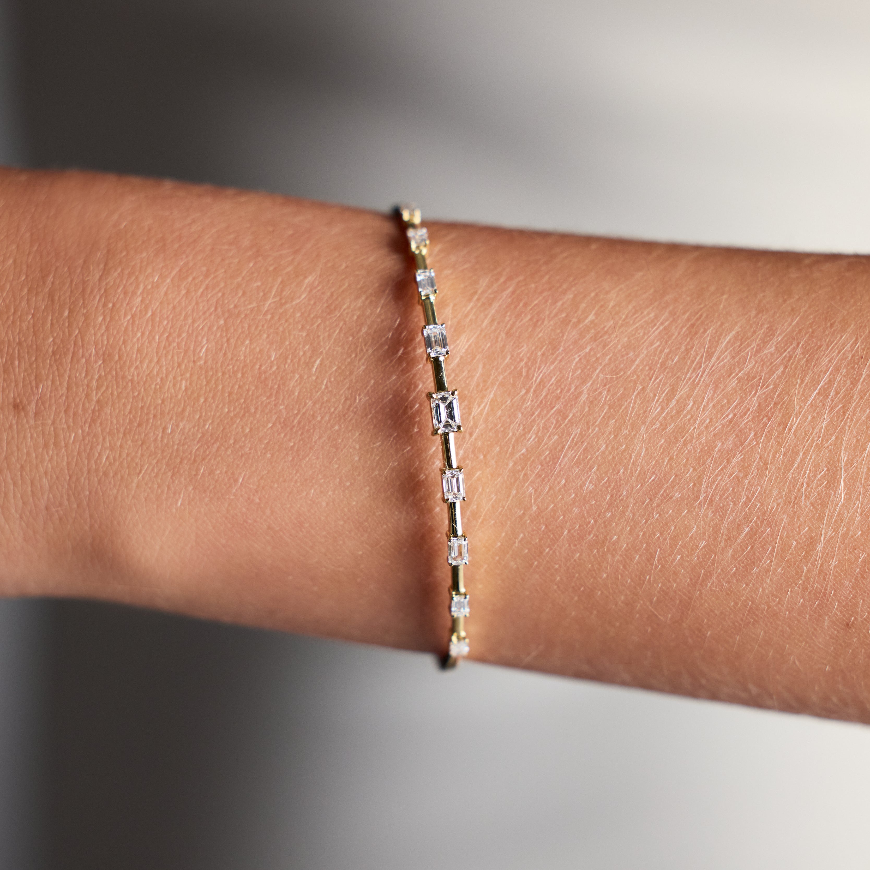 Slim diamond bangle featuring 1.20ct baguette diamonds in yellow gold