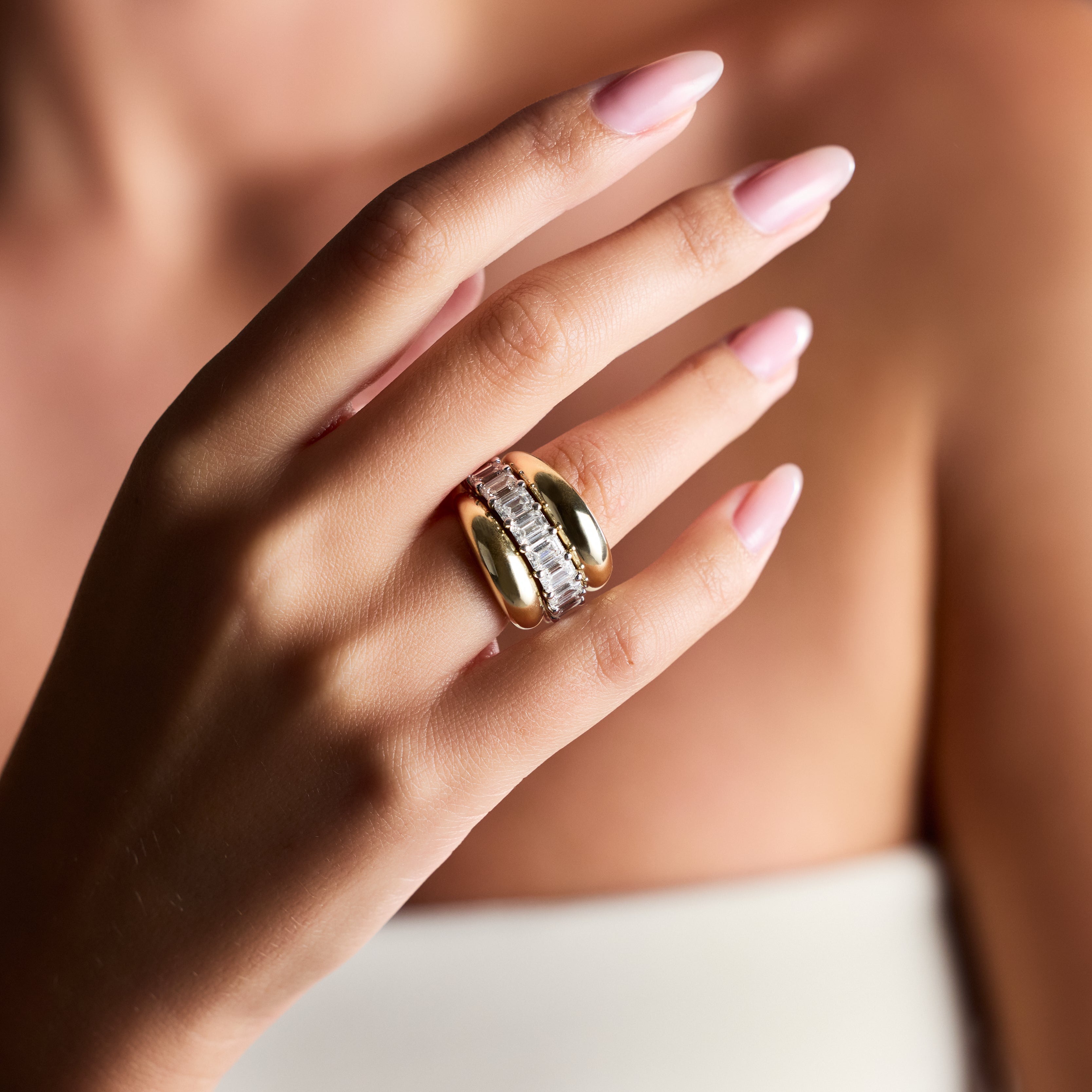 Woman showcasing polished 14K yellow gold dome band