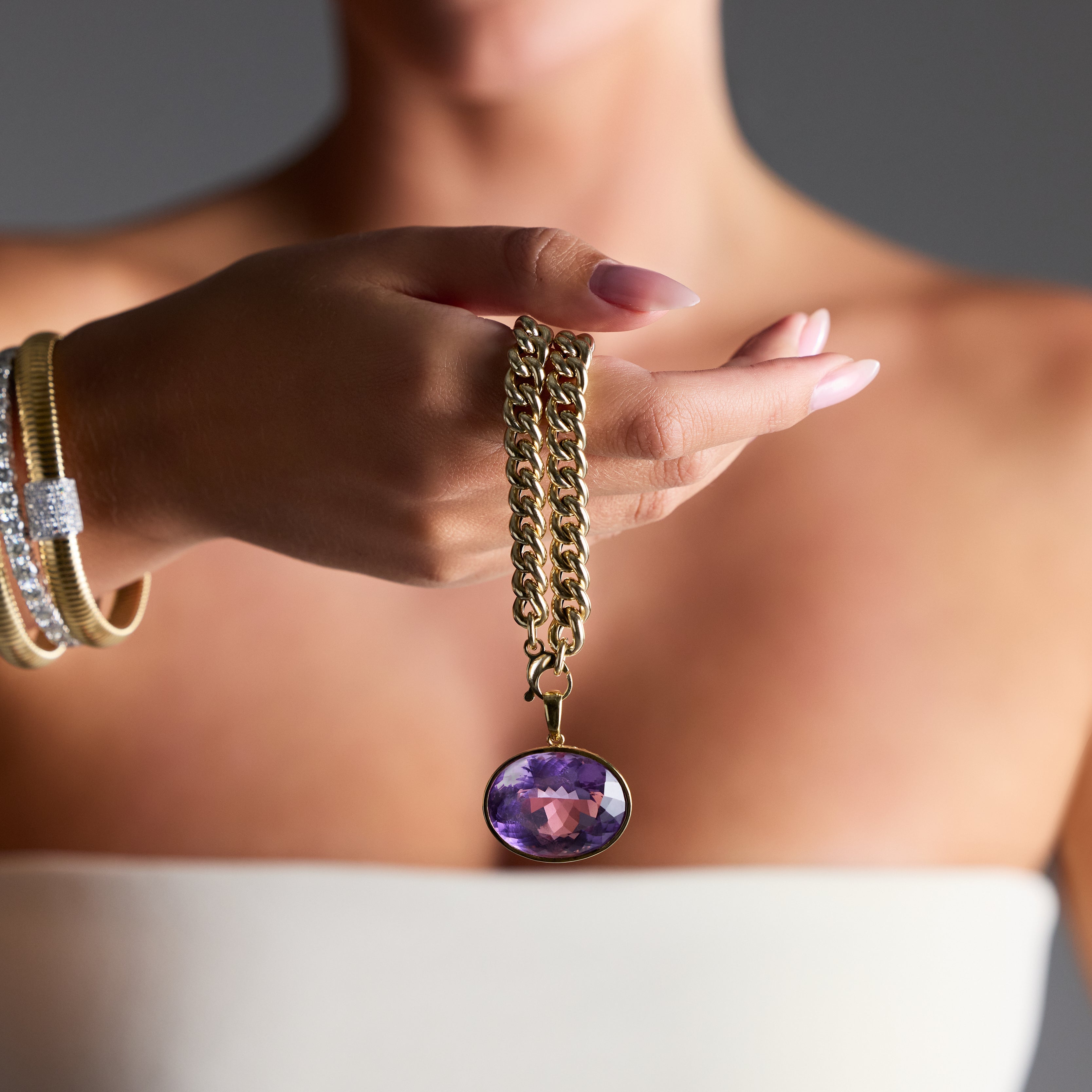 Statement gemstone pendant featuring an oval amethyst in gold