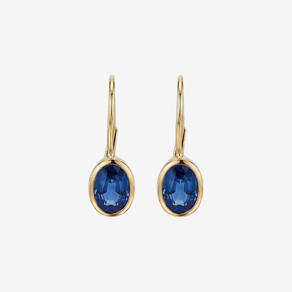 Oval Bezel Gemstone Leverback Earrings in 14K Yellow Gold with Blue Sapphire, gray background | JJ Jewelry Miami