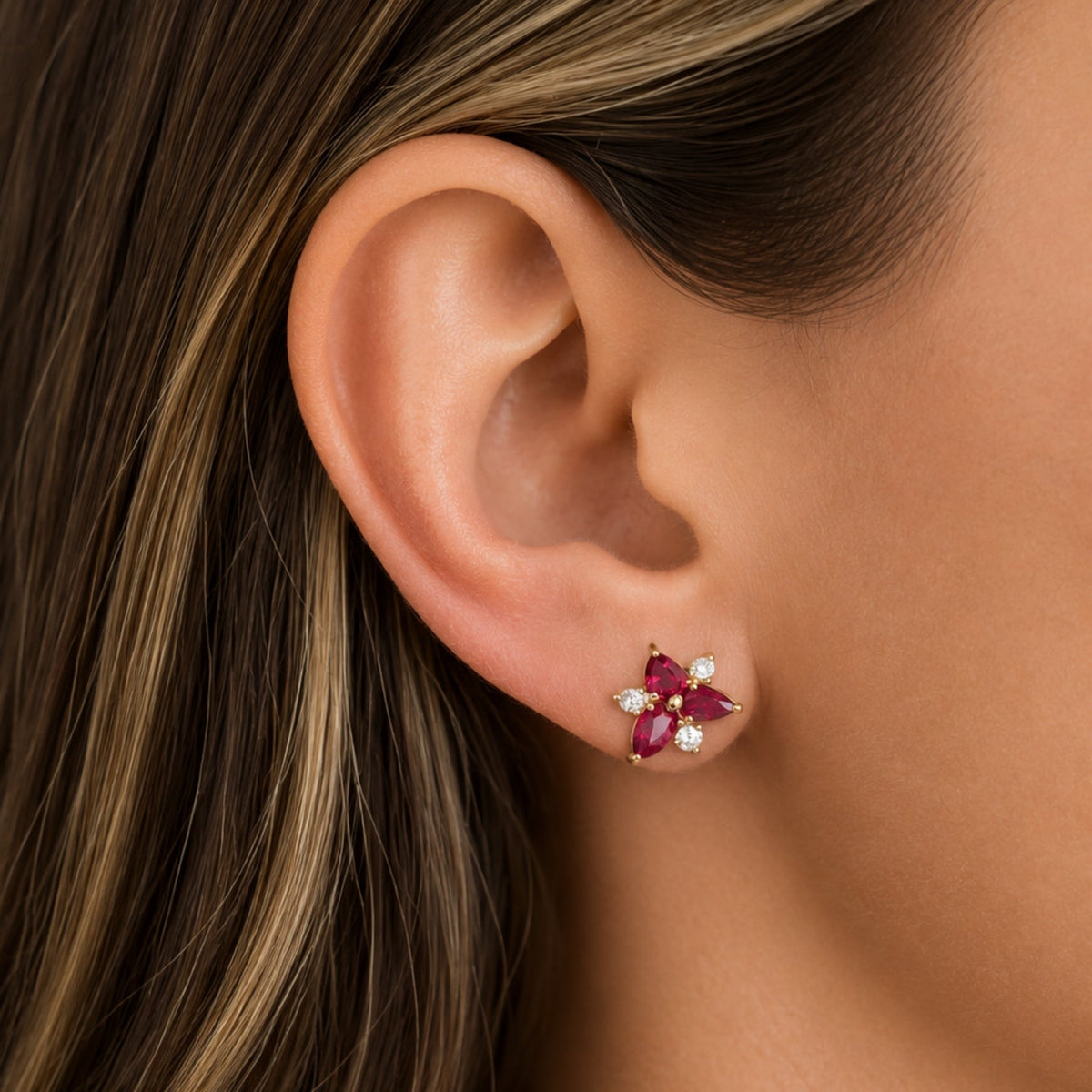 Ruby and Diamond Stud Earrings in 14K Yellow Gold, on ear | JJ Jewelry Miami