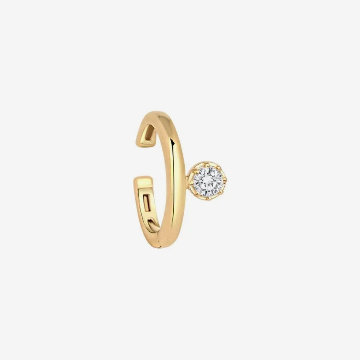 Single Diamond Ear Clip in 18K Yellow Gold, gray background | JJ Jewelry Miami