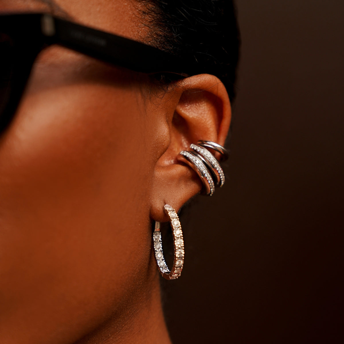 Diamond Pavé Curve Ear Cuffs in 18K yellow and white gold stacked with diamond hoops, worn on model | JJ Jewelry Miami