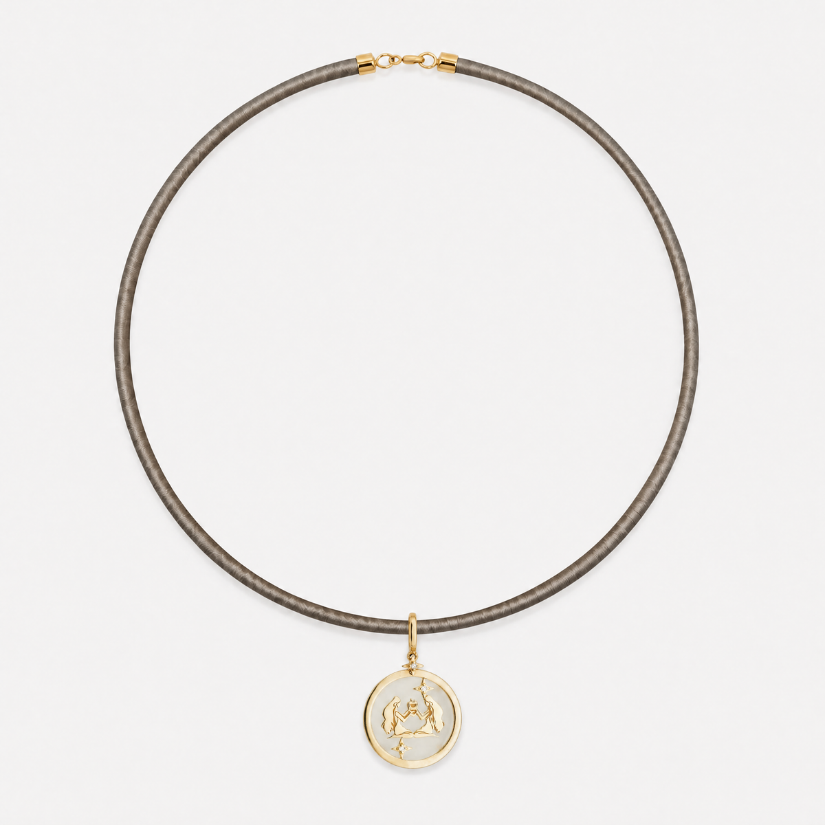 Gemini Zodiac Pendant in 18K Yellow Gold with White Quartz & Diamonds, styled on a taupe cord choker | JJ Jewelry Miami
