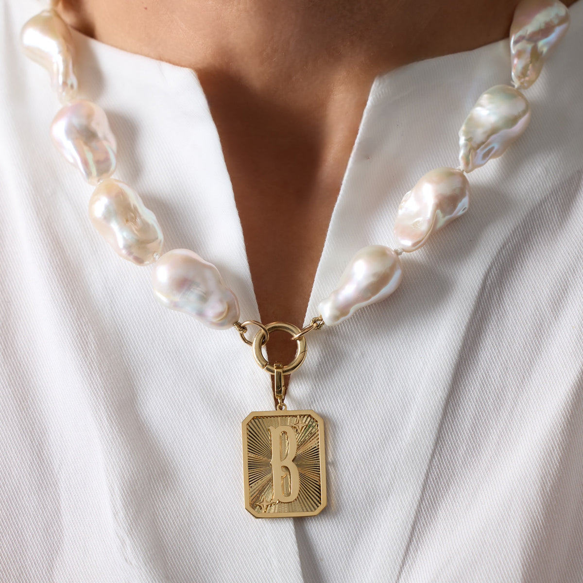 Large Initial Medal Pendant in 18K Yellow Gold, letter B, on a baroque pearl necklace | JJ Jewelry Miami