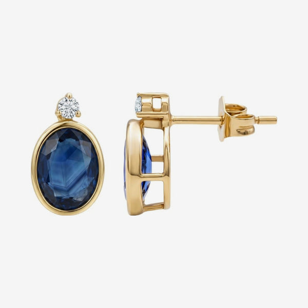 Oval Blue Sapphire Bezel Stud Earrings in 14K Yellow Gold, gray background | JJ Jewelry Miami