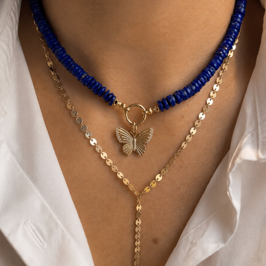 Pavé Diamond Butterfly Pendant in 14K Yellow Gold, layered with a lapis bead necklace | JJ Jewelry Miami