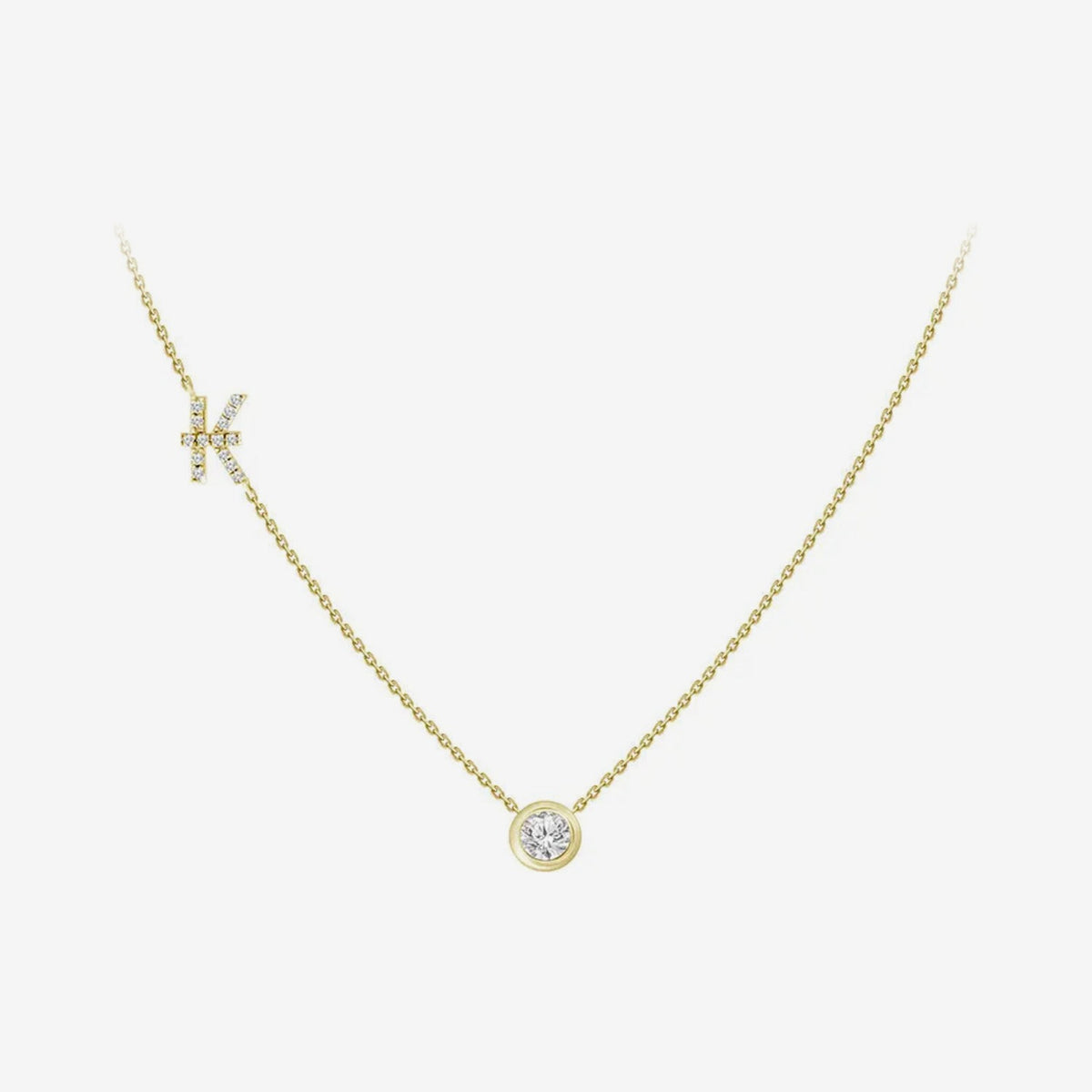 Pavé Diamond Initial Necklace, Letter K, in 18K Yellow Gold, gray background | JJ Jewelry Miami