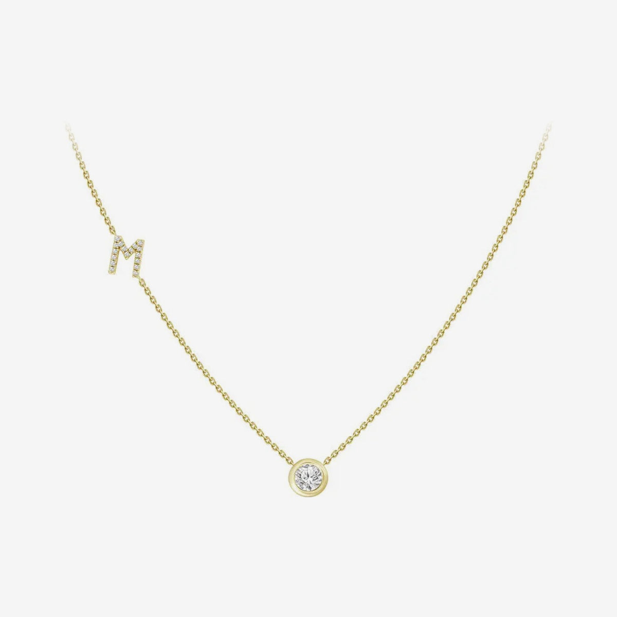 Pavé Diamond Initial Necklace, Letter M, in 18K Yellow Gold, gray background | JJ Jewelry Miami