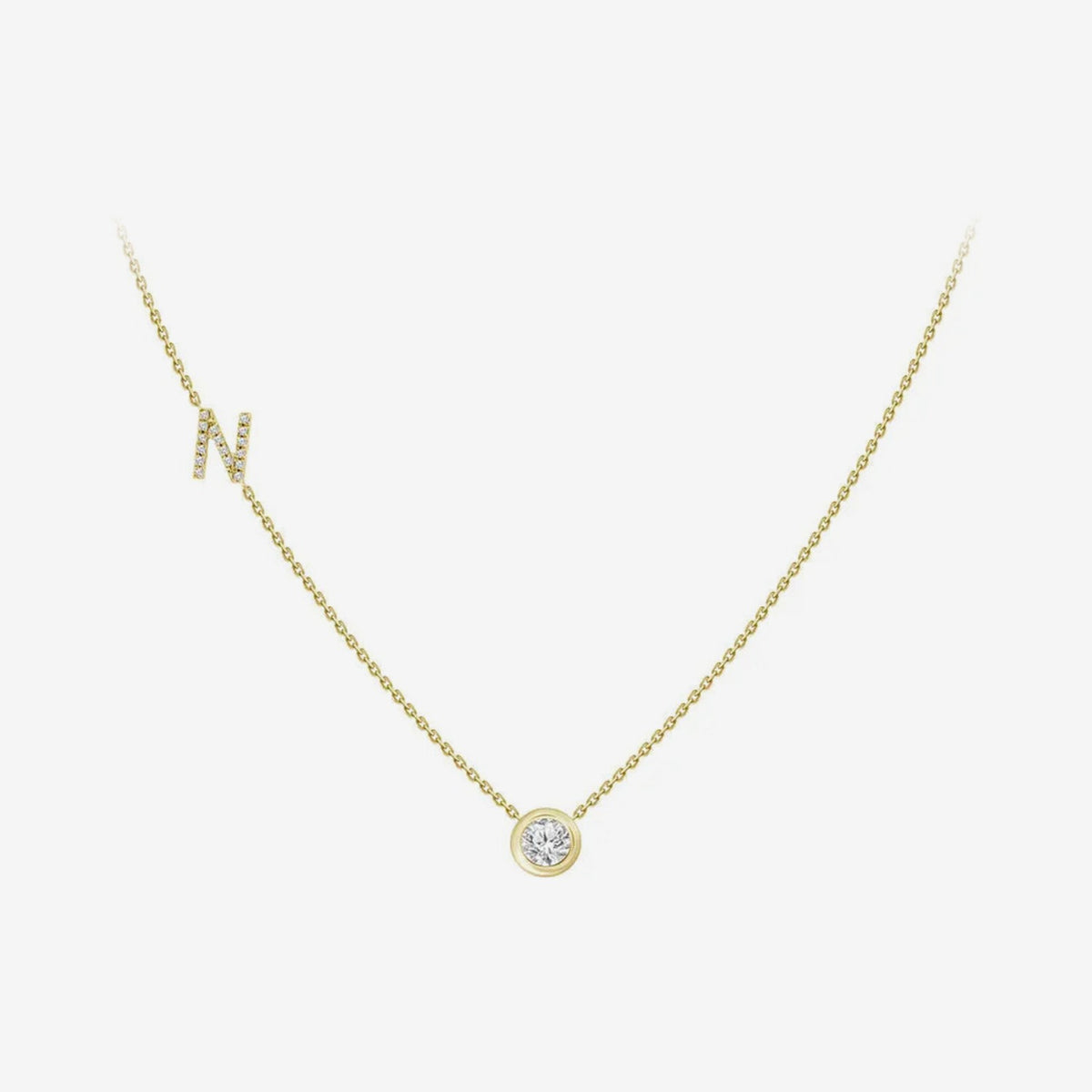 Pavé Diamond Initial Necklace, Letter N, in 18K Yellow Gold, gray background | JJ Jewelry Miami