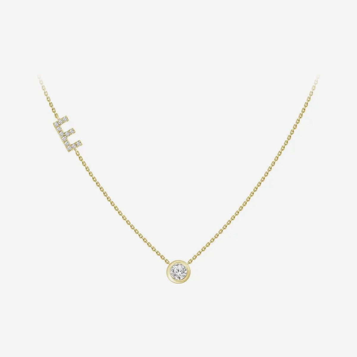 Pavé Diamond Initial Necklace, Letter E, in 18K Yellow Gold, gray background | JJ Jewelry Miami