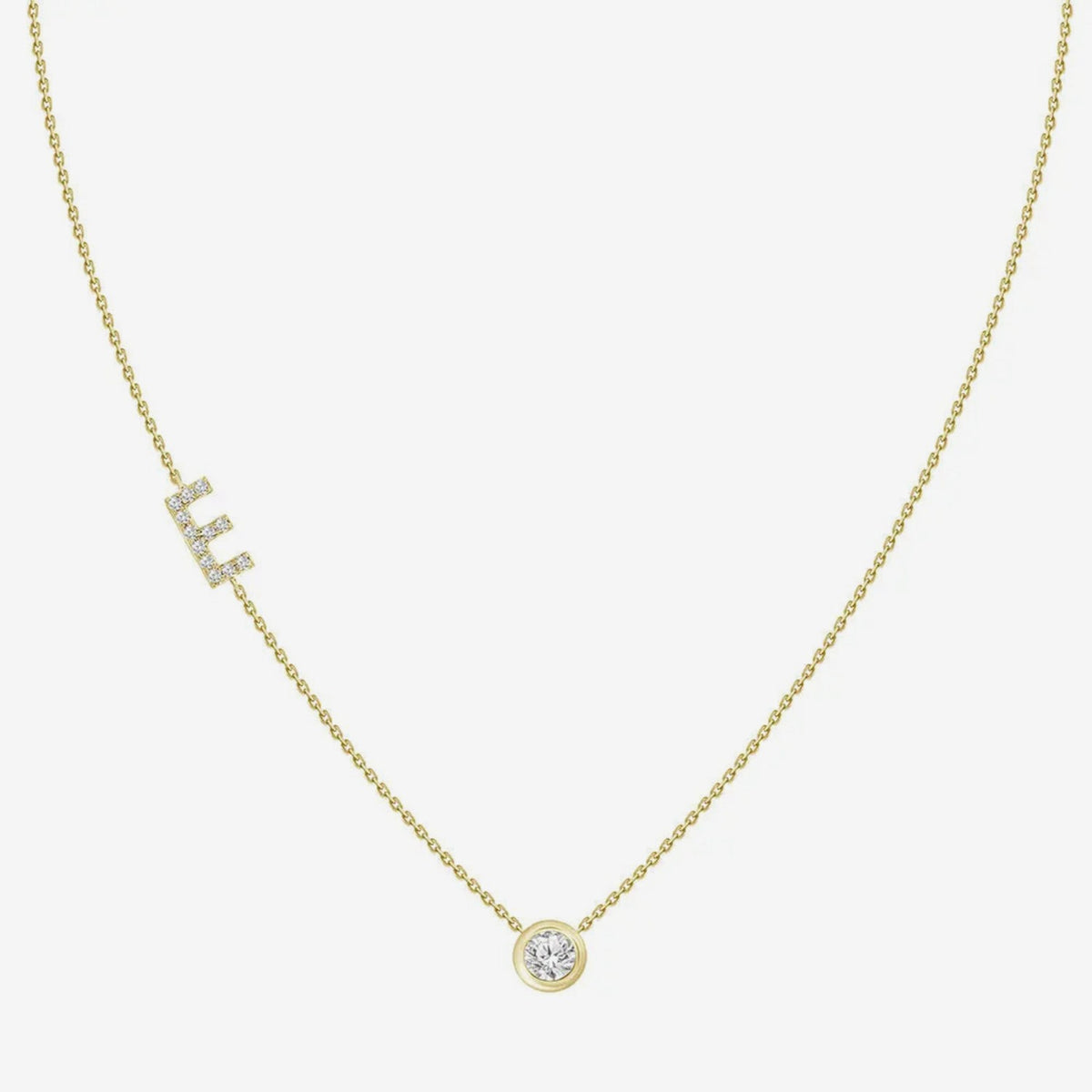 Pavé Diamond Initial Necklace, Letter E, in 18K Yellow Gold, gray background | JJ Jewelry Miami
