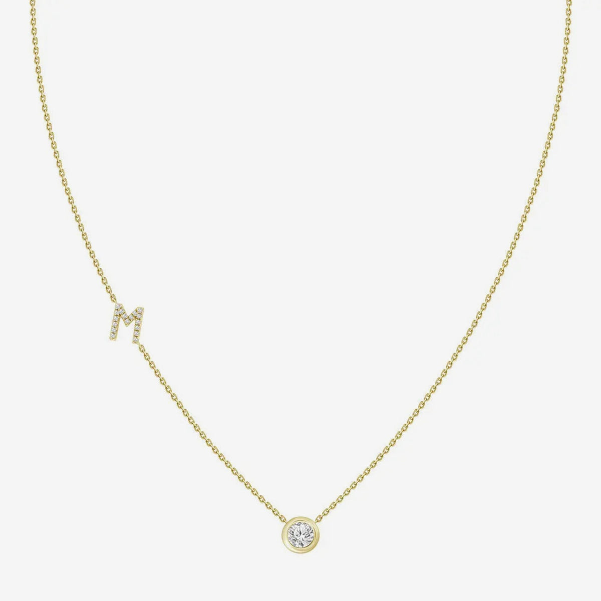 Pavé Diamond Initial Necklace, Letter M, in 18K Yellow Gold, gray background | JJ Jewelry Miami