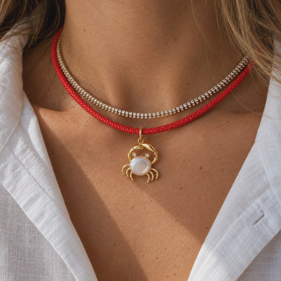 Mother-of-Pearl Crab Pendant with Diamonds in 14K Yellow Gold, layered with coral and gold beaded necklaces, video | JJ Jewelry Miami