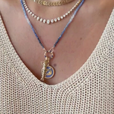 Pisces Zodiac Pendant in 18K Yellow Gold with Blue Quartz & Diamonds, layered with a blue bead necklace, video | JJ Jewelry Miami